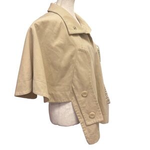 Cream coloured lined cape with pockets